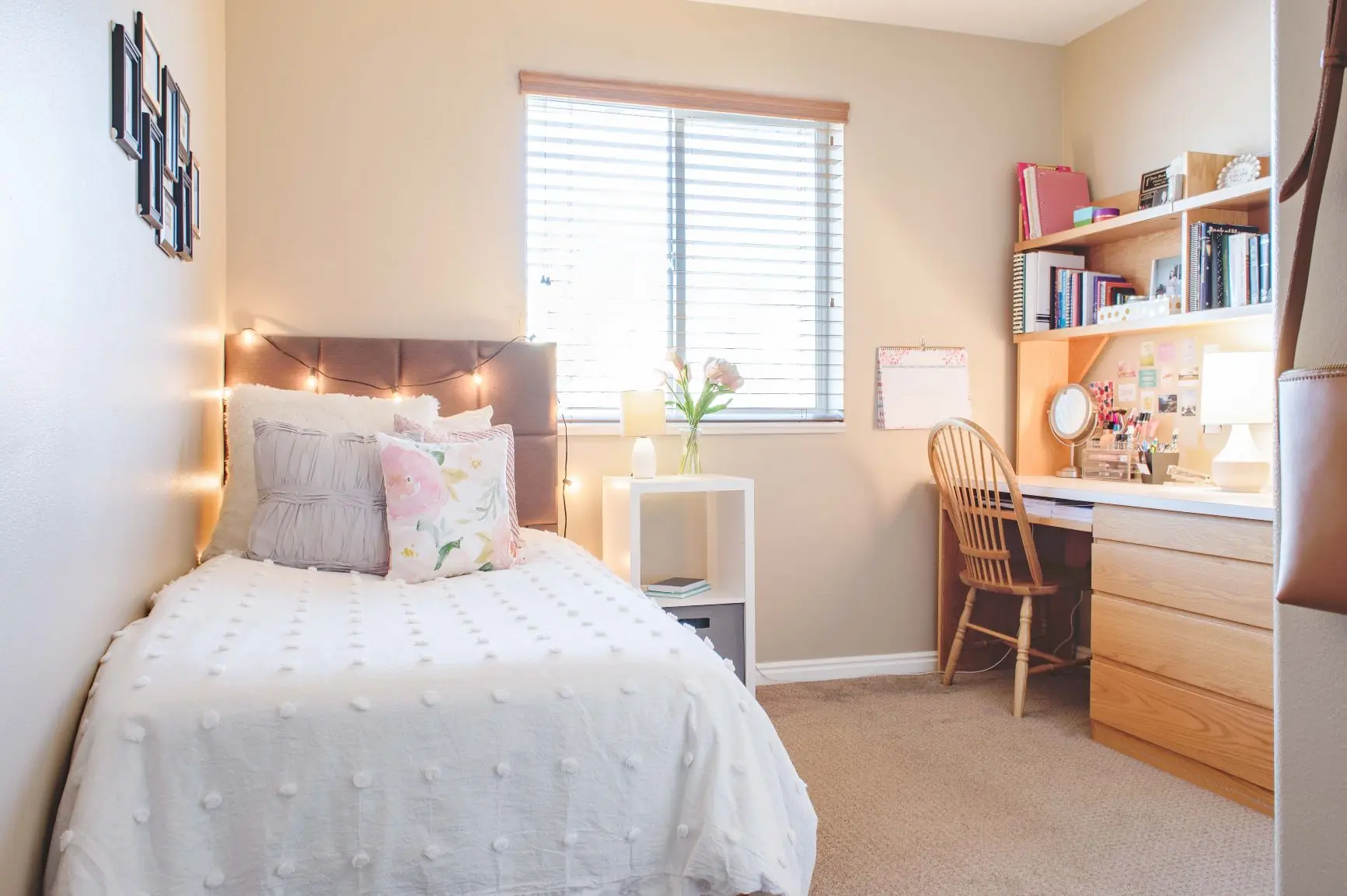 Bedroom with Neatly Made Bed, Desk, and Window with Blinds